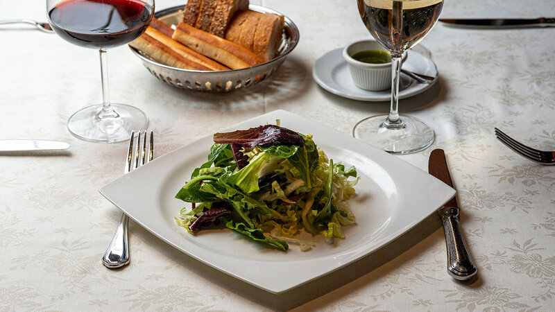 Arugula salad with a glass of white wine